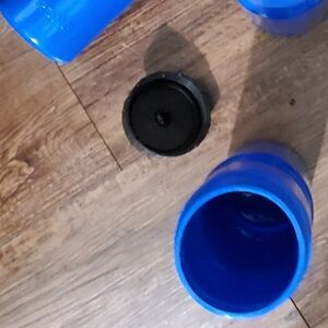 New Blue Firm Plastic Pull Top Water Bottle With Saying at bottom "BE 50 strong)